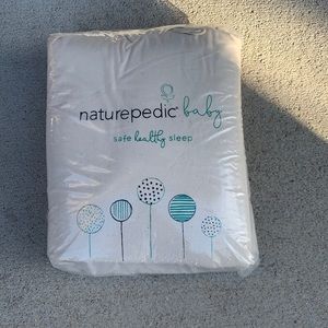 Never opened Naturpedic crib mattress cover